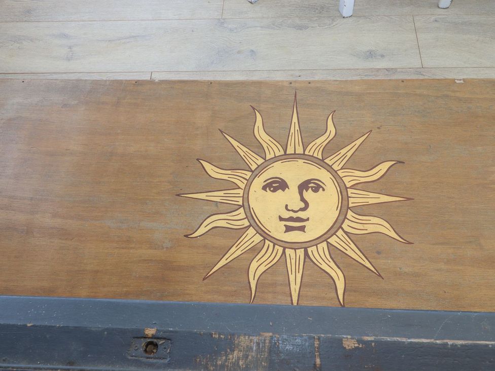 A sun design on a wooden surface at Greengates in Rye