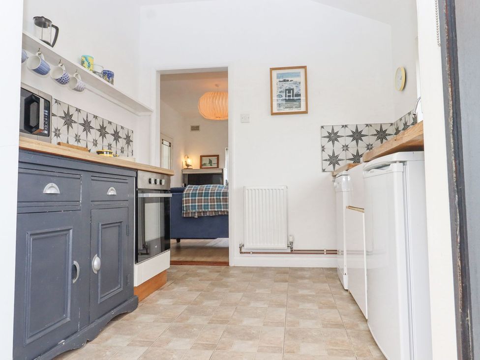 A kitchen with cabinets and appliances at Greengates in Rye