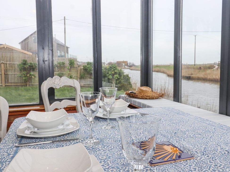 A dining room with a table set for a meal at Greengates in Rye