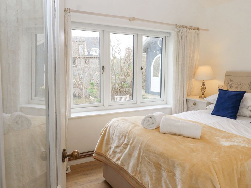 A bedroom with a bed and window at Greengates in Rye