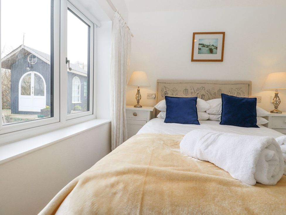 A bedroom with a bed and window at Greengates in Rye