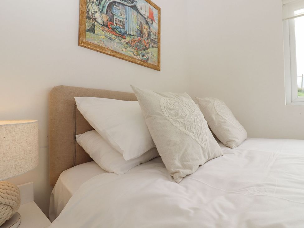 A bedroom with a bed and lamp at Greengates in Rye