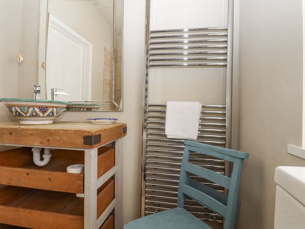 A bathroom with a sink and mirror at Greengates in Rye