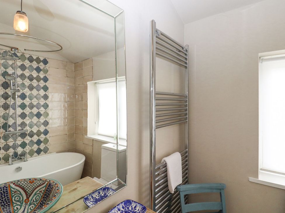 A bathroom featuring a bathtub, shower, and mirror at Greengates in Rye
