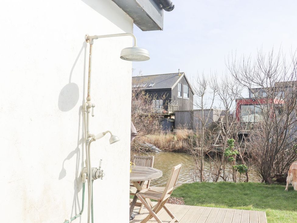 An outdoor shower next to a wooden deck at Greengates in Rye
