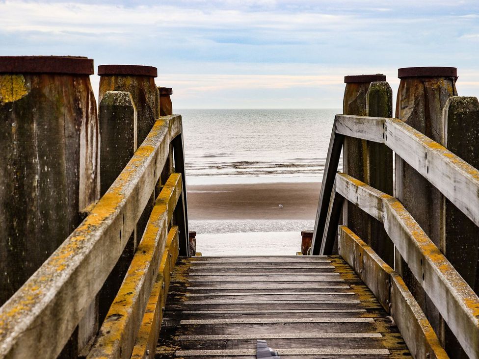 Wooden stairs leading down to the beach at Greengates in Rye