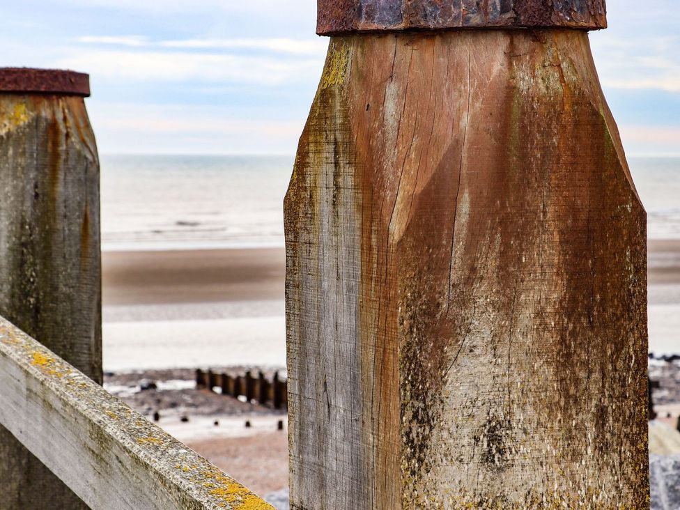 Wooden posts with ocean in background at Greengates in Rye