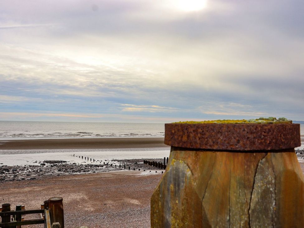 A beach view with a wooden post and the sea at Greengates in Rye