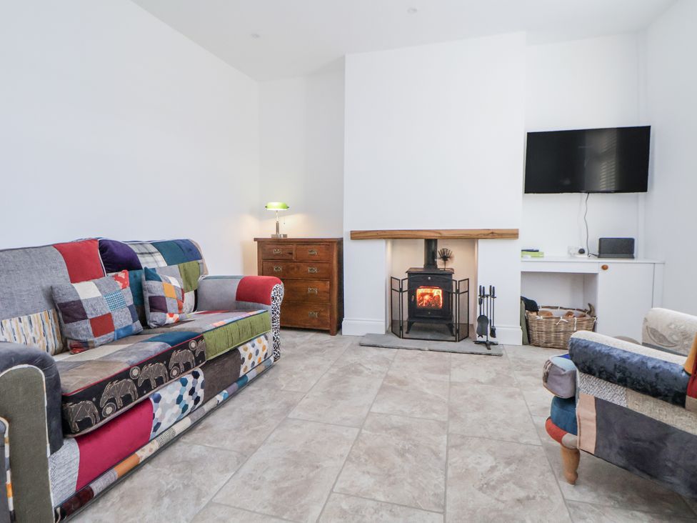 A living room with a fireplace and sofas at 10 South Street in Rossendale
