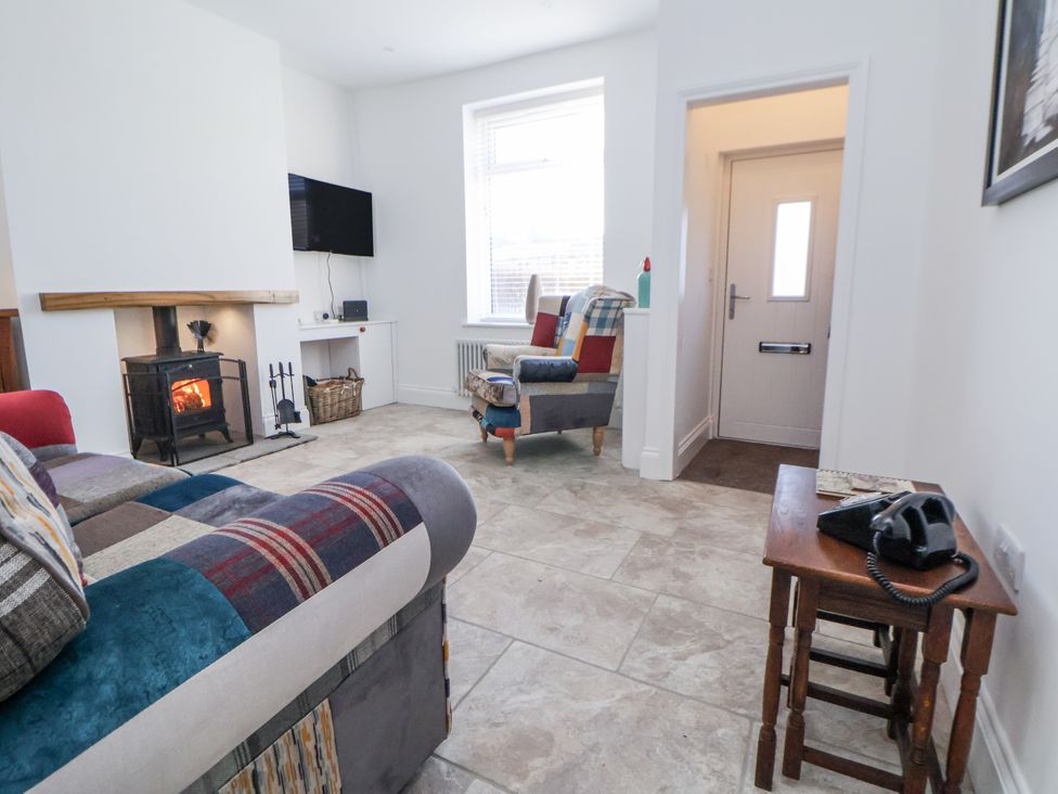 A living room with a fireplace and sofa at 10 South Street in Rossendale