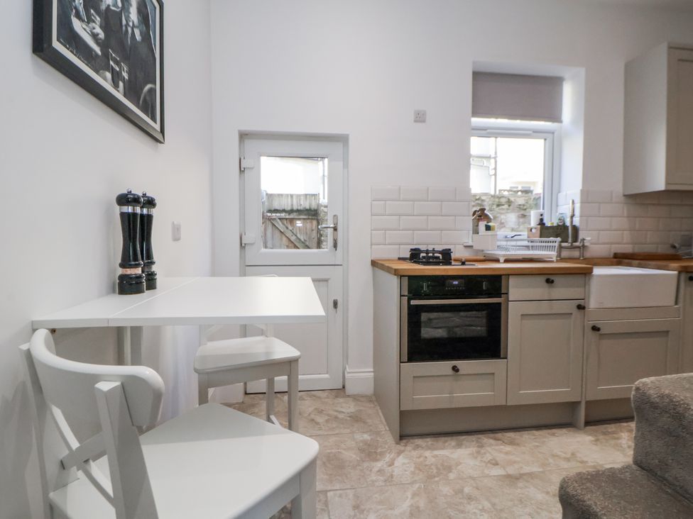 A kitchen with a table and chairs at 10 South Street in Rossendale