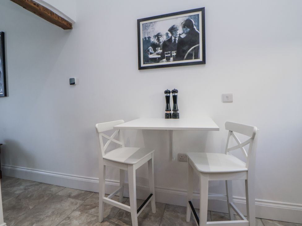 A table and two chairs with pepper and salt grinders at 10 South Street in Rossendale