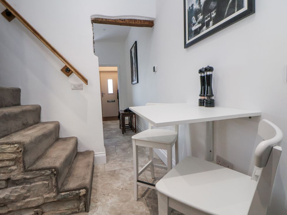 A hallway with stairs and a table at 10 South Street in Rossendale