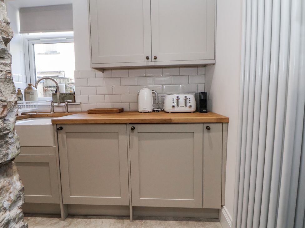 A kitchen with a sink and appliances at 10 South Street in Rossendale