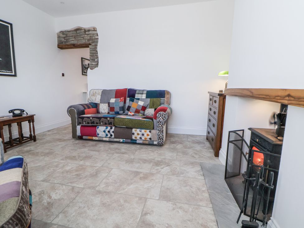 A living room with a sofa and telephone at 10 South Street in Rossendale