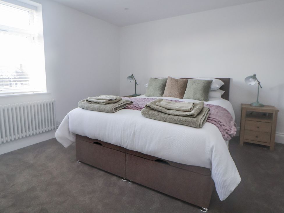 A bedroom with a bed and bedside table at 10 South Street in Rossendale