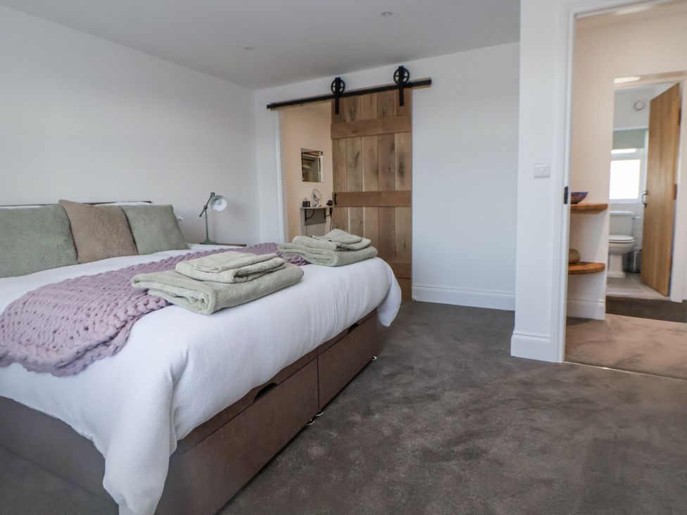 A bedroom with a bed and towels at 10 South Street in Rossendale