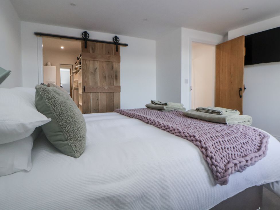A bedroom with a bed and towels at 10 South Street in Rossendale