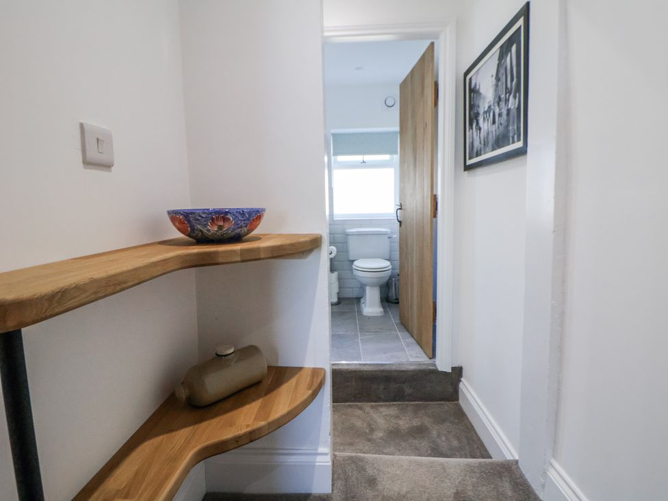 A hallway leading to a bathroom with a toilet at 10 South Street in Rossendale