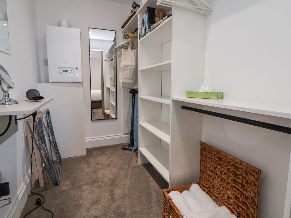 A closet with shelves and a mirror at 10 South Street, Rossendale