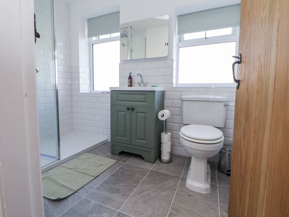 A bathroom with a shower and wash basin at 10 South Street in Rossendale