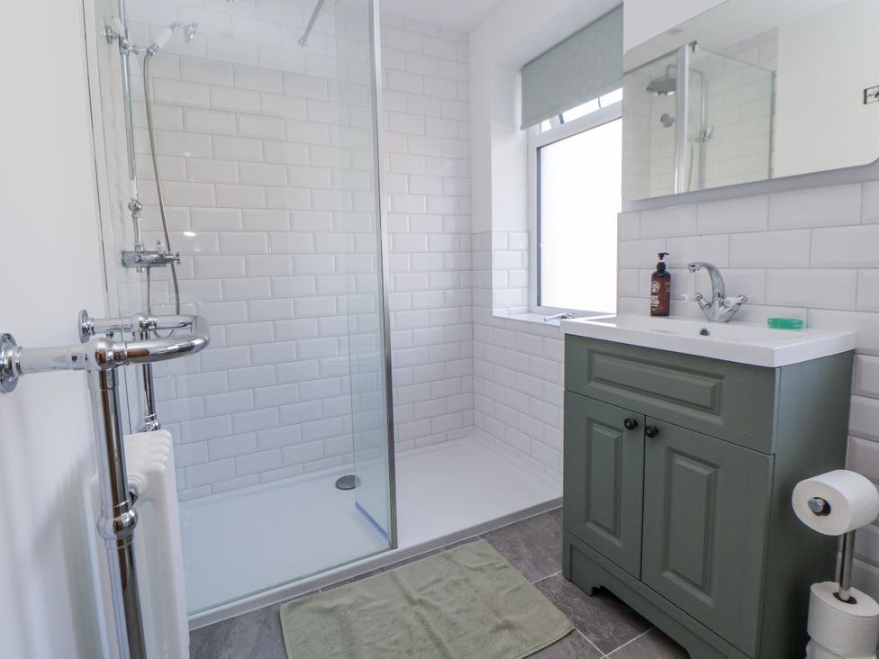 A bathroom featuring a shower, sink and vanity at 10 South Street in Rossendale