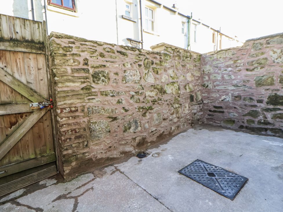 An outdoor area with a stone wall and wooden gate at 10 South Street Rossendale