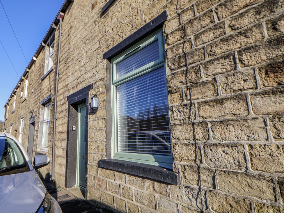 An exterior view of a stone house with a door and window at 10 South Street Rossendale