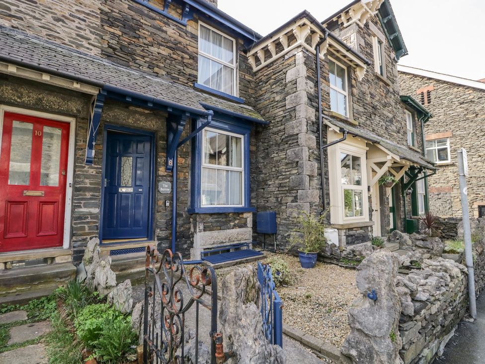 A stone house with red and blue doors at The Burrow in Windermere