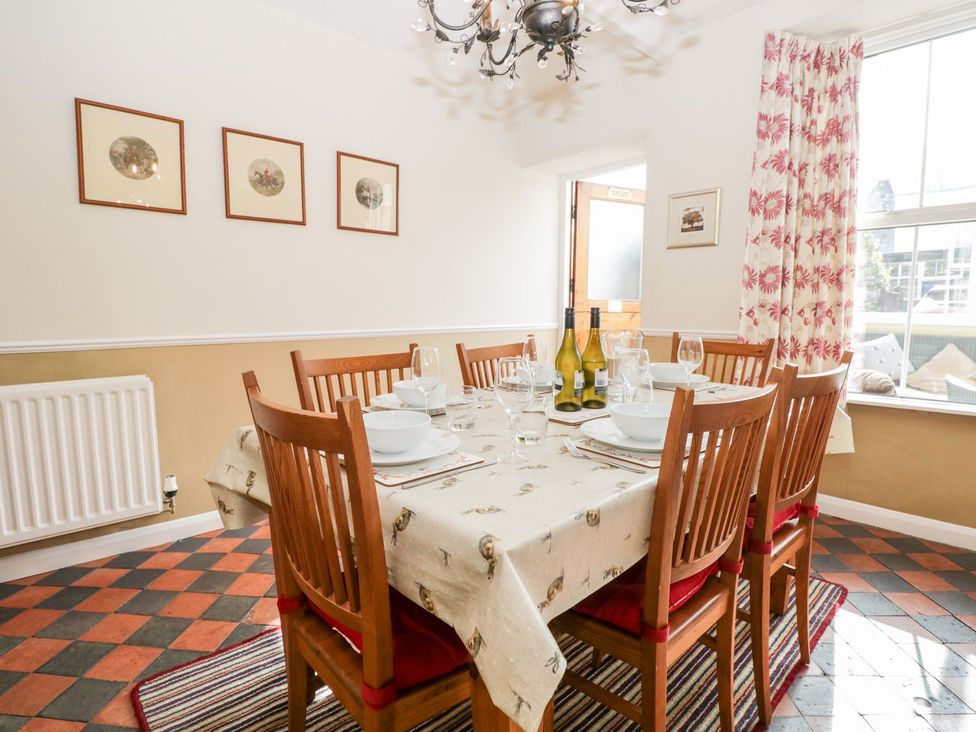A dining room with a table set for dinner at The Burrow in Windermere