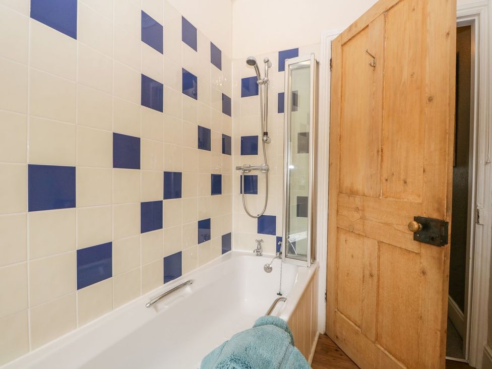 A bathroom with a bathtub and shower at The Burrow in Windermere