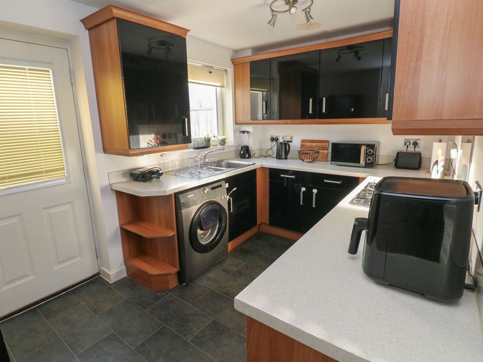 A kitchen with appliances and cabinets at 9 Ffordd Donaldson Swansea
