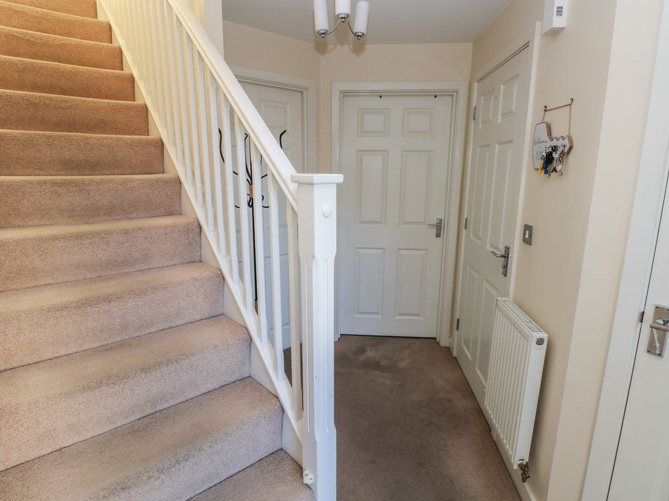 A hallway with stairs and doors at 9 Ffordd Donaldson Swansea