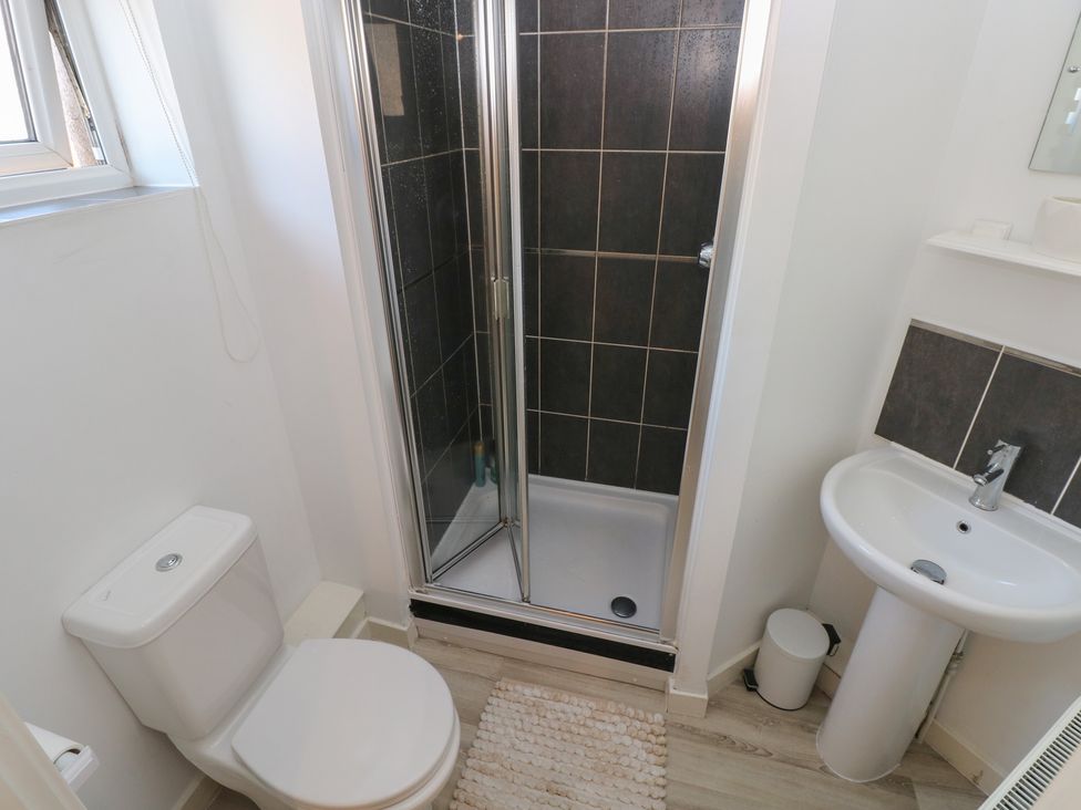 A bathroom with a shower, toilet, and sink at 9 Ffordd Donaldson Swansea
