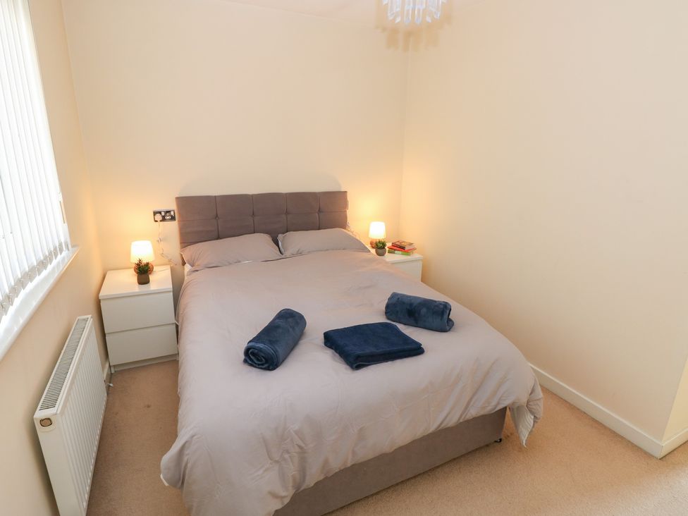 A bedroom with a bed and nightstands at Swansea Escape in Swansea