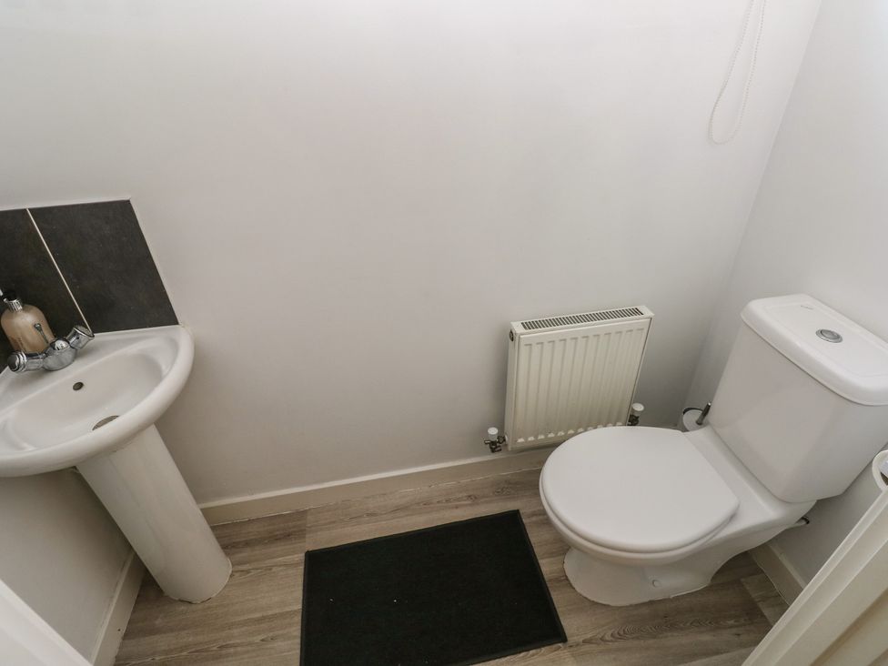 A bathroom with a sink and toilet at Swansea Escape in Swansea