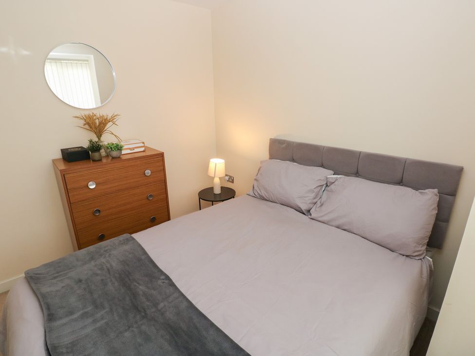 A bedroom with a bed and a dresser at Swansea Escape in Swansea