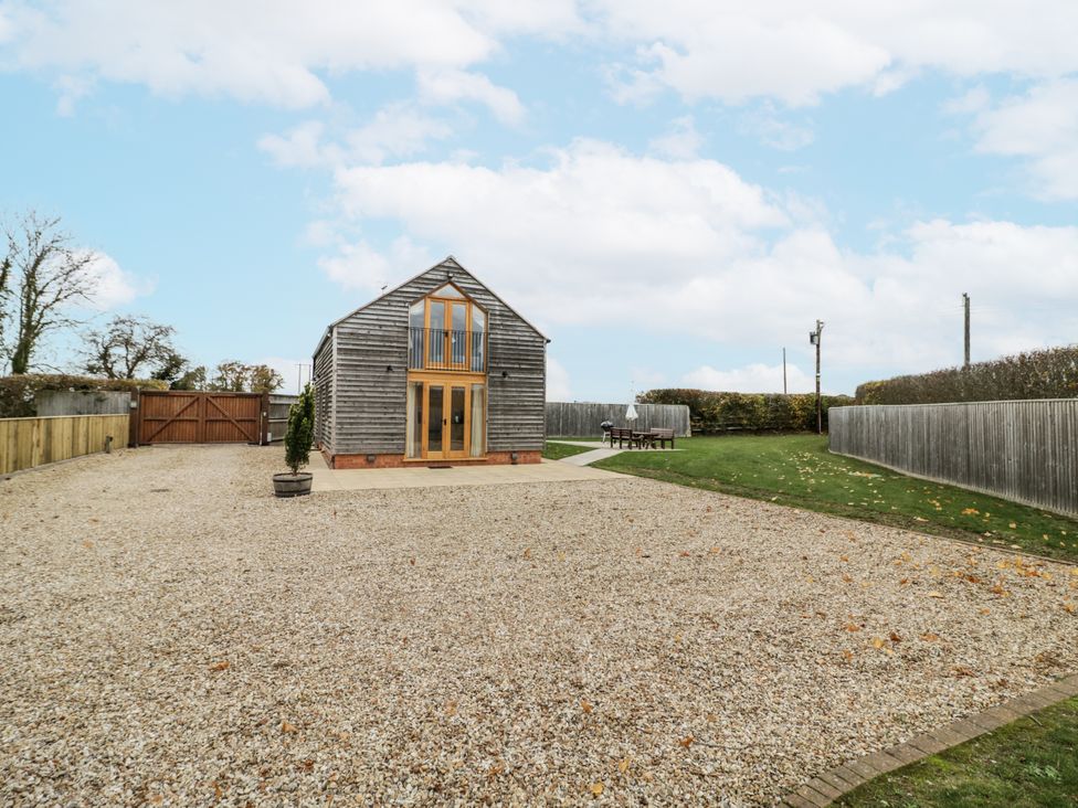 An outdoor area with a house and table at Cedar Barn in 