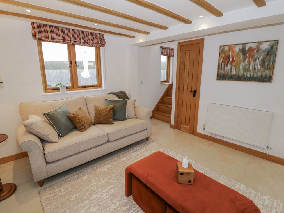 A living room with a sofa and coffee table at Cedar Barn