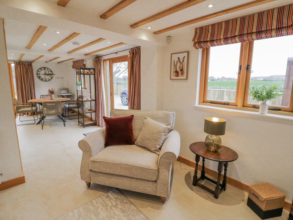 A living room with a sofa and lamp at Cedar Barn
