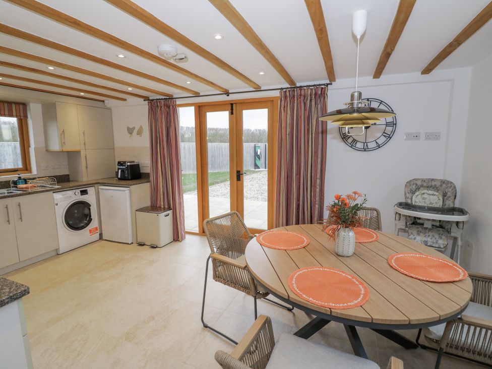 A kitchen with a table and chairs at Cedar Barn