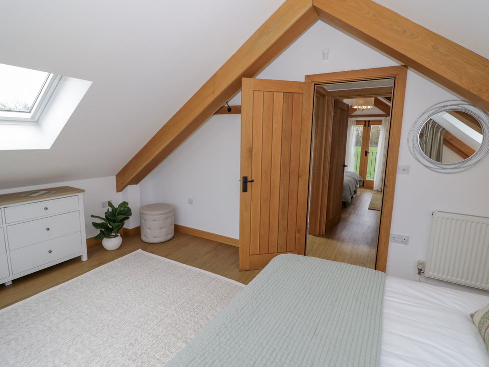 A bedroom with a skylight and a plant at Cedar Barn in 