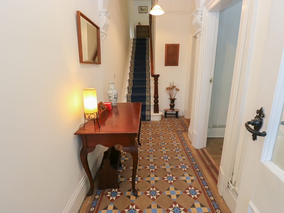A hallway with a table and lamp at 27 Calton terrace Skipton