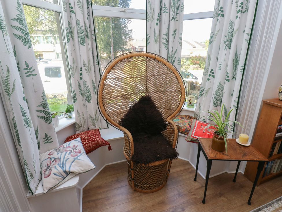 A living room with a chair and table at 27 Calton terrace in Skipton