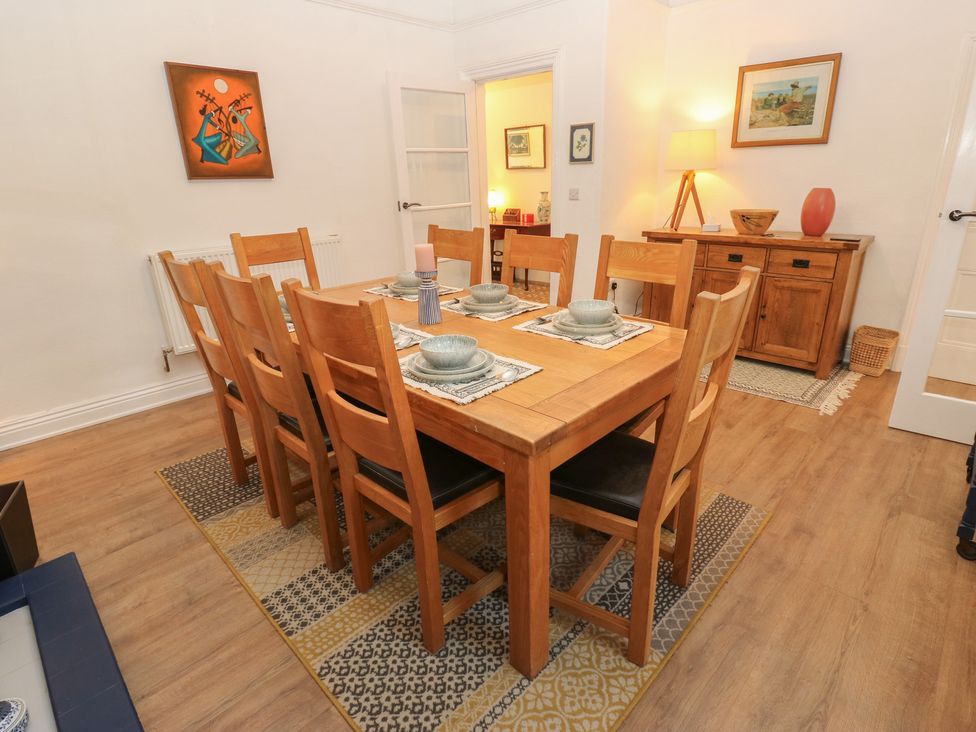 A dining room with a wooden table and chairs at 27 Calton terrace Skipton