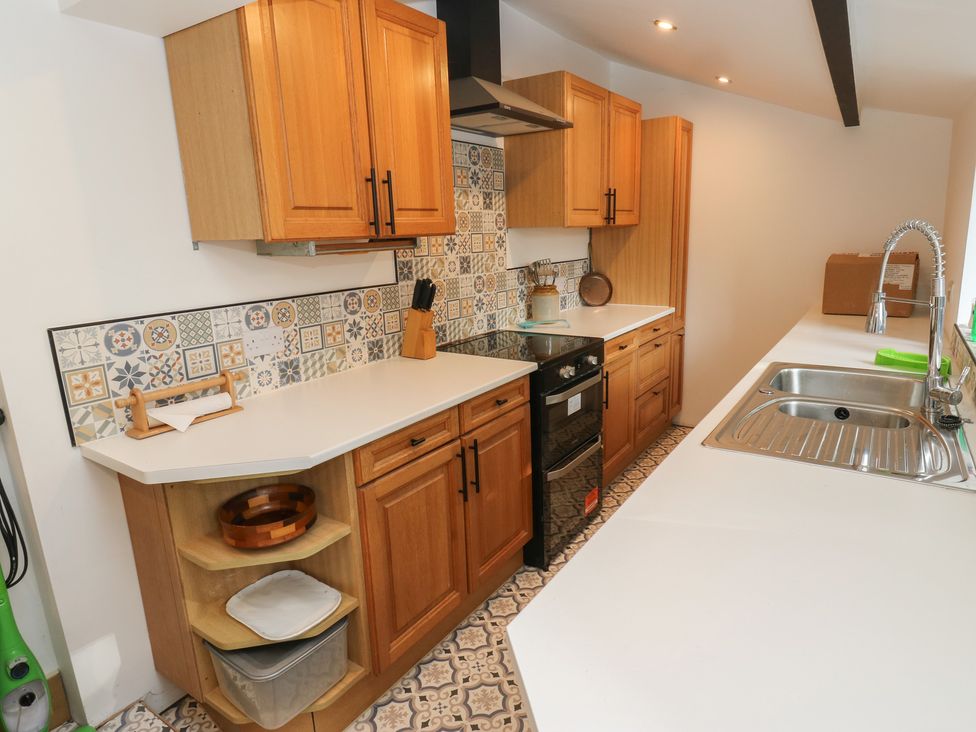 A kitchen with cabinets and a stove at 27 Calton terrace in Skipton
