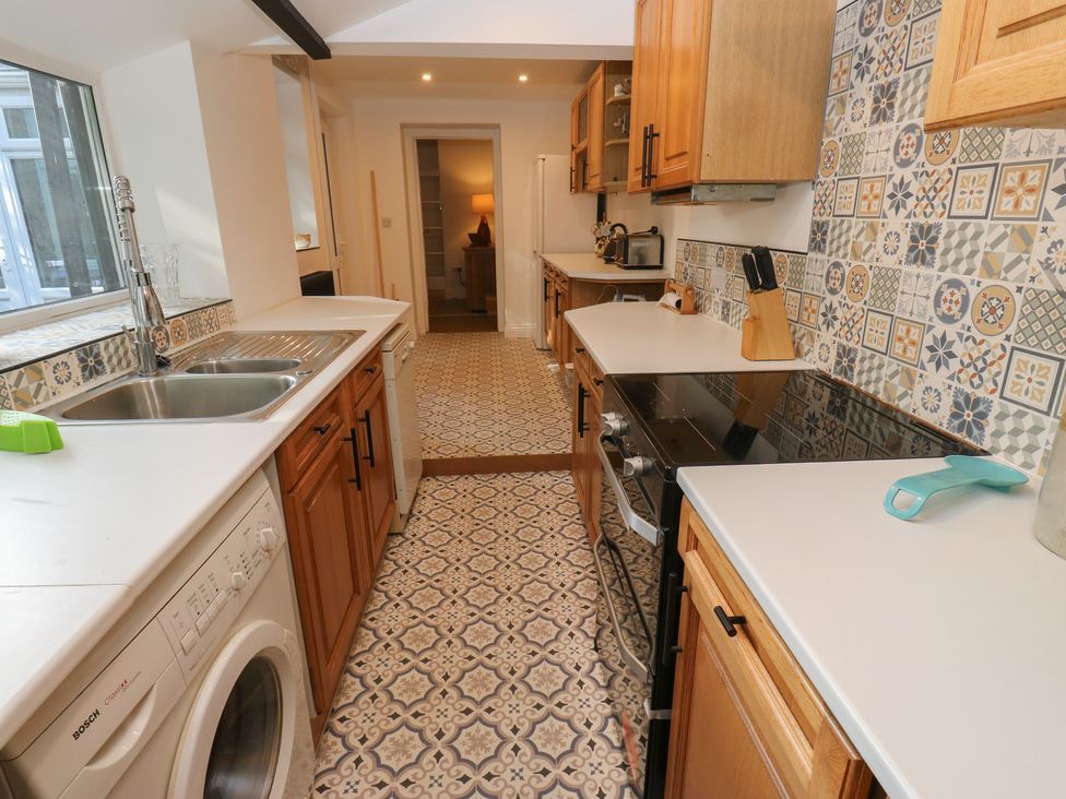 A kitchen with appliances and cabinets at 27 Calton terrace in Skipton