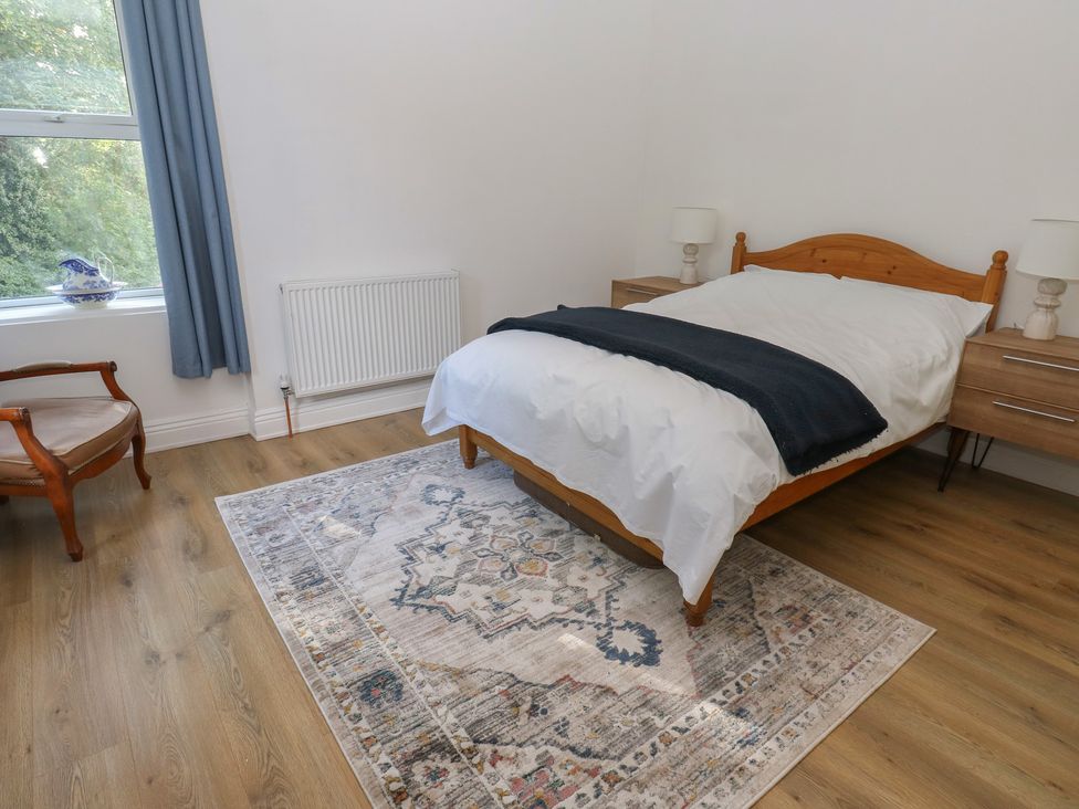 A bedroom with a bed and nightstands at 27 Calton terrace in Skipton