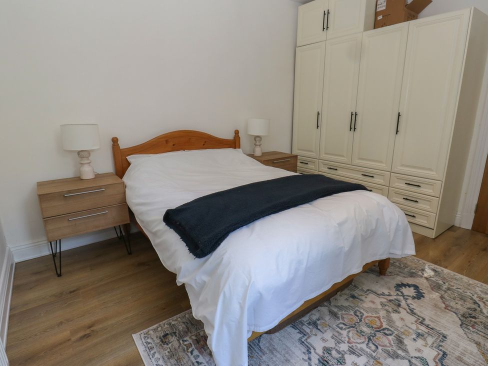 A bedroom with a bed and nightstands at 27 Calton terrace Skipton