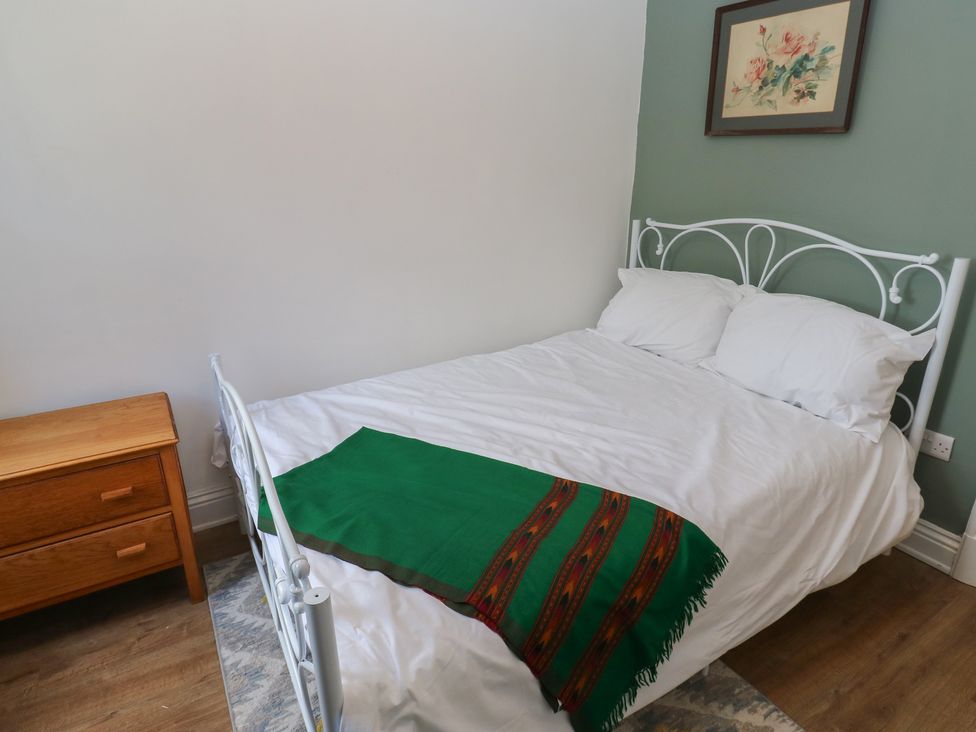 A bedroom with a bed and nightstand at 27 Calton terrace in Skipton